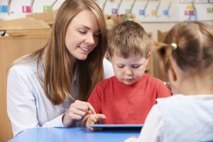 Teacher assessing young student