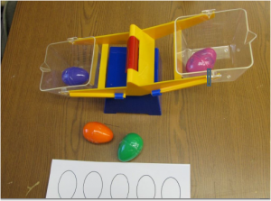 Picture of toy scale weighing plastic eggs
